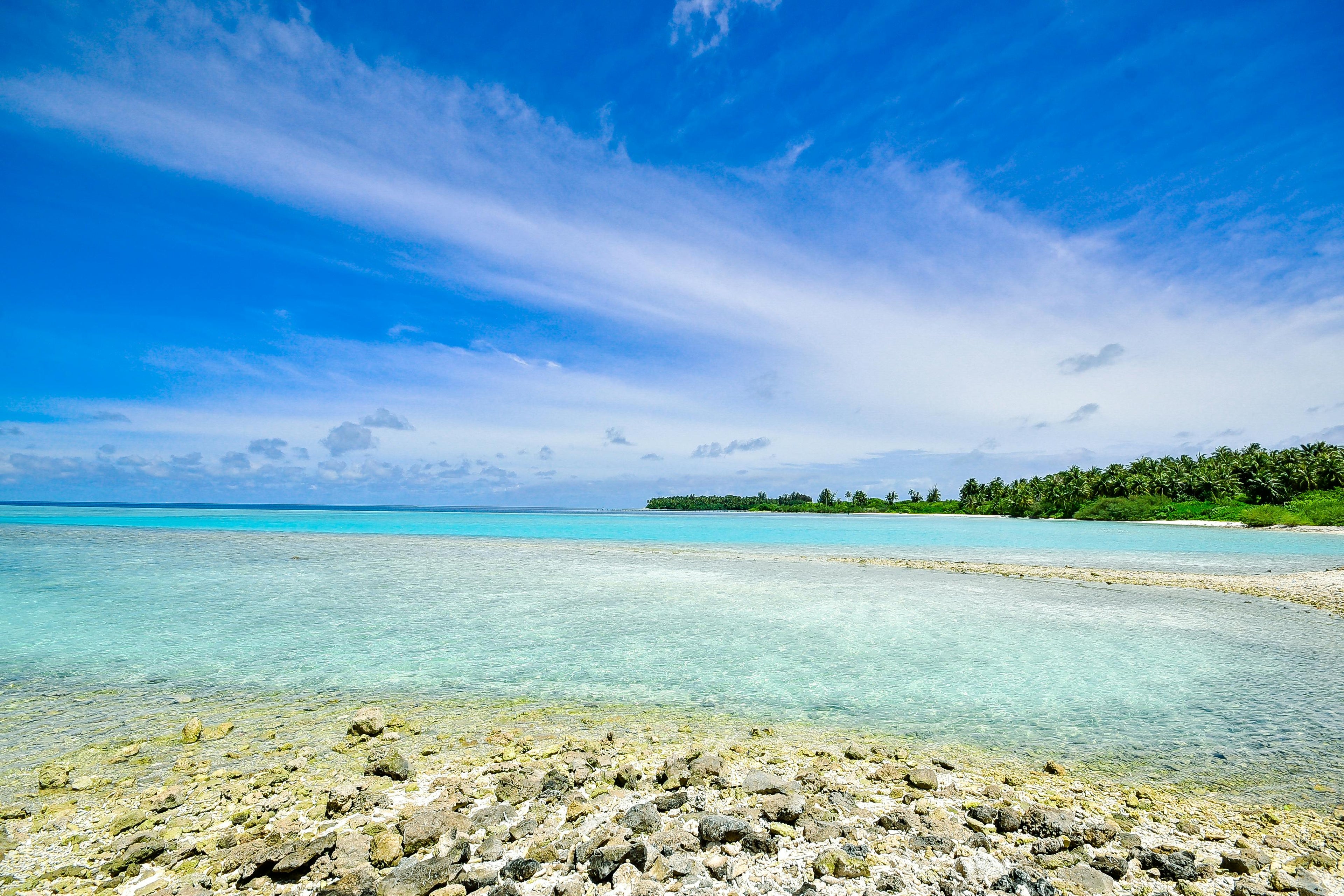 Boat anchored in clear Florida waters with coastal horizon