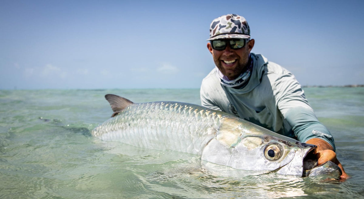 Florida fisherman with massive tarpon caught in crystal water
