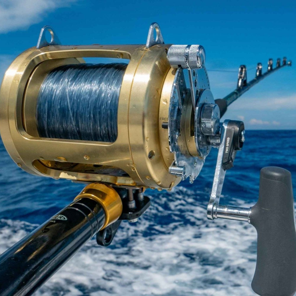 Close-up of a fishing reel with a blue ocean background