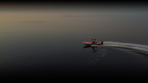 Boat running at dusk with underwater lighting