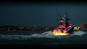Boat at night with underwater LED glow