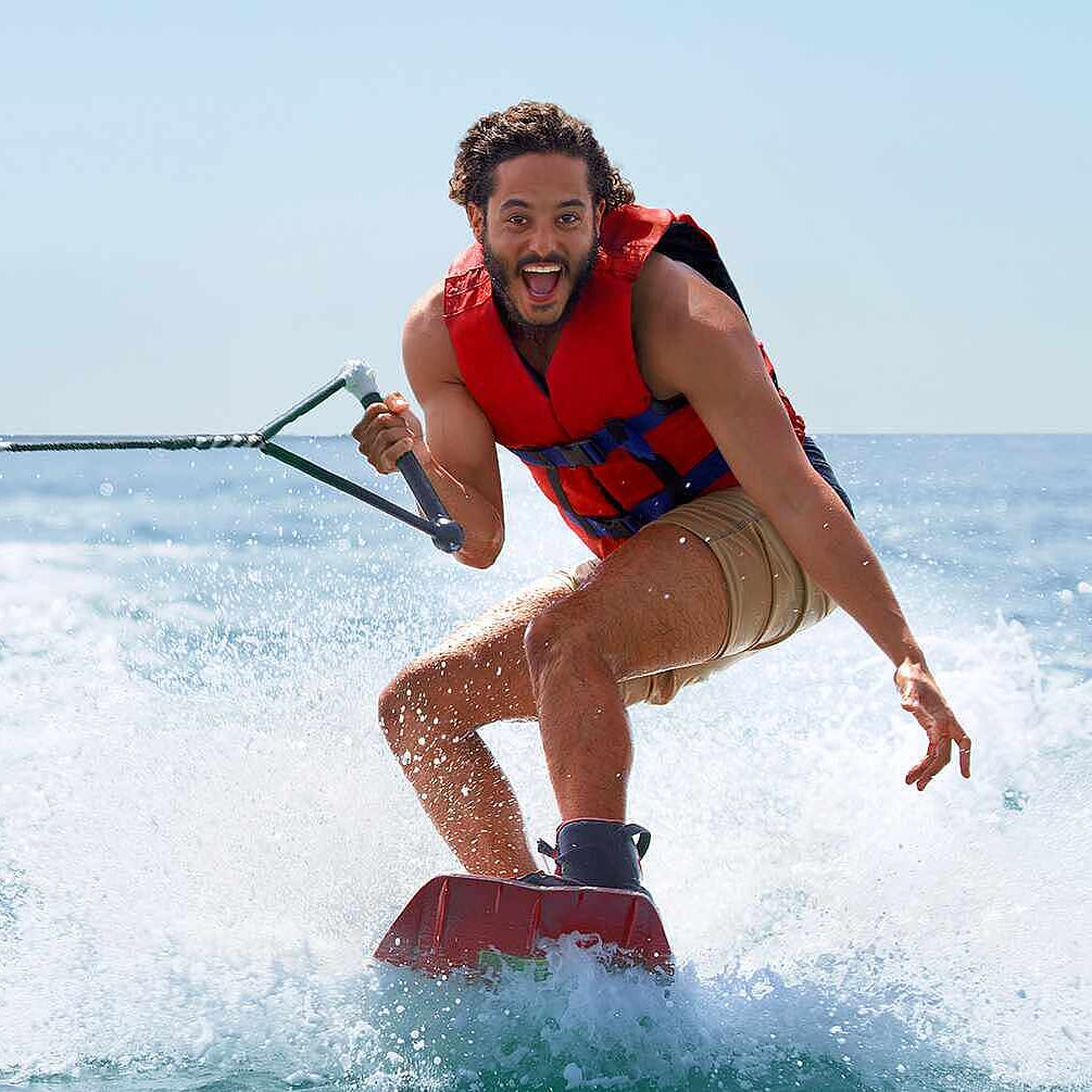 Person water skiing on a clear day with blue water
